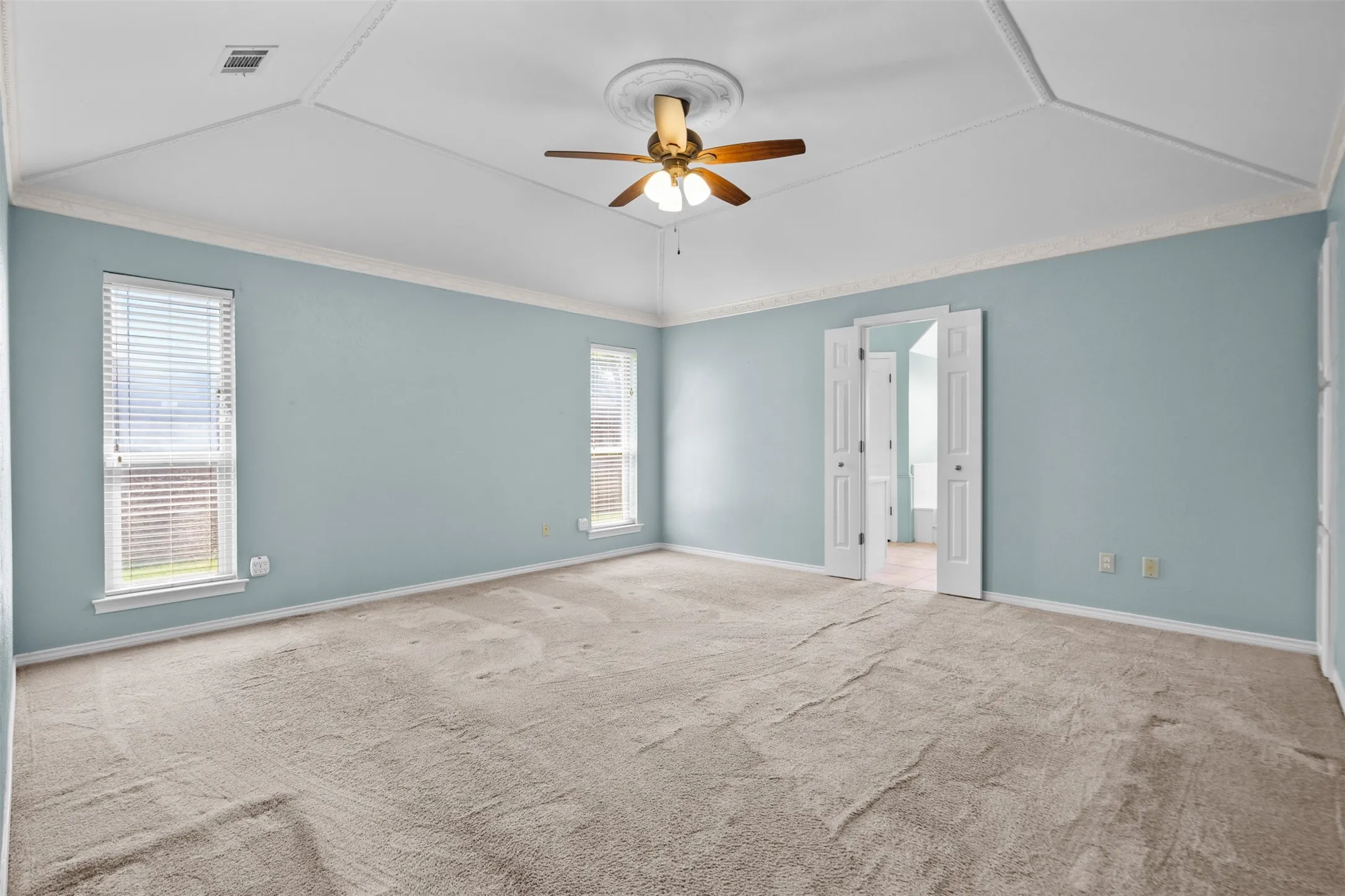 Primary bedroom with vaulted ceilings