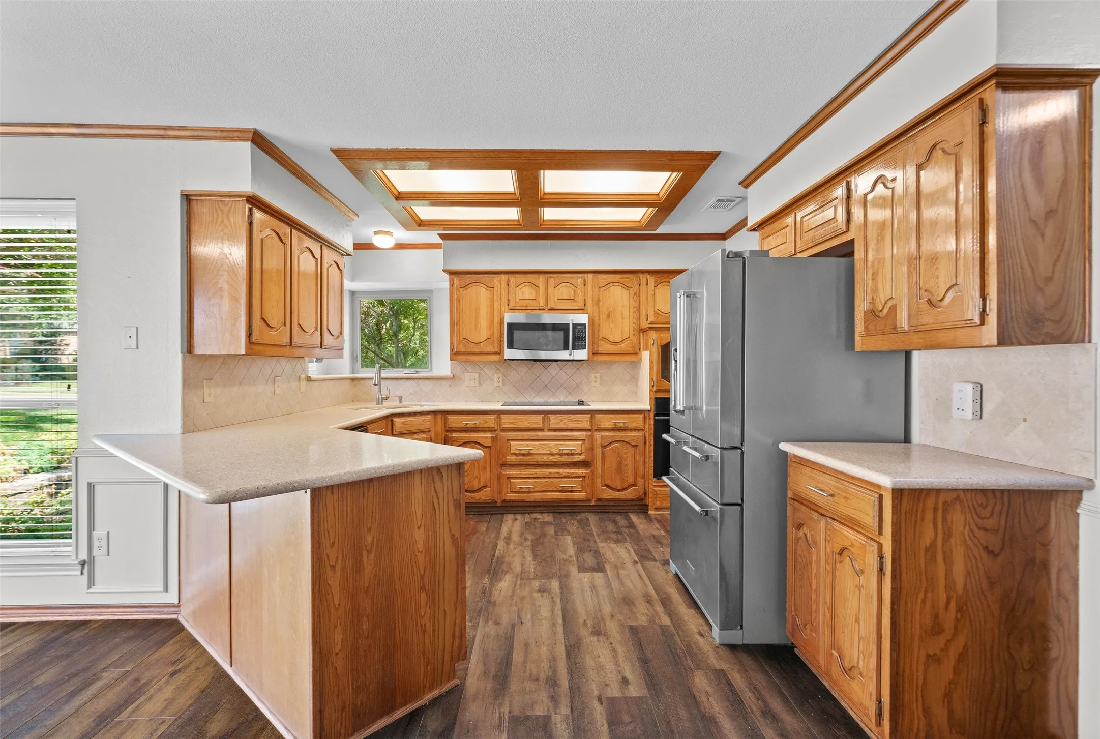 Bright kitchen with stainless steel KitchenAid refrigerator