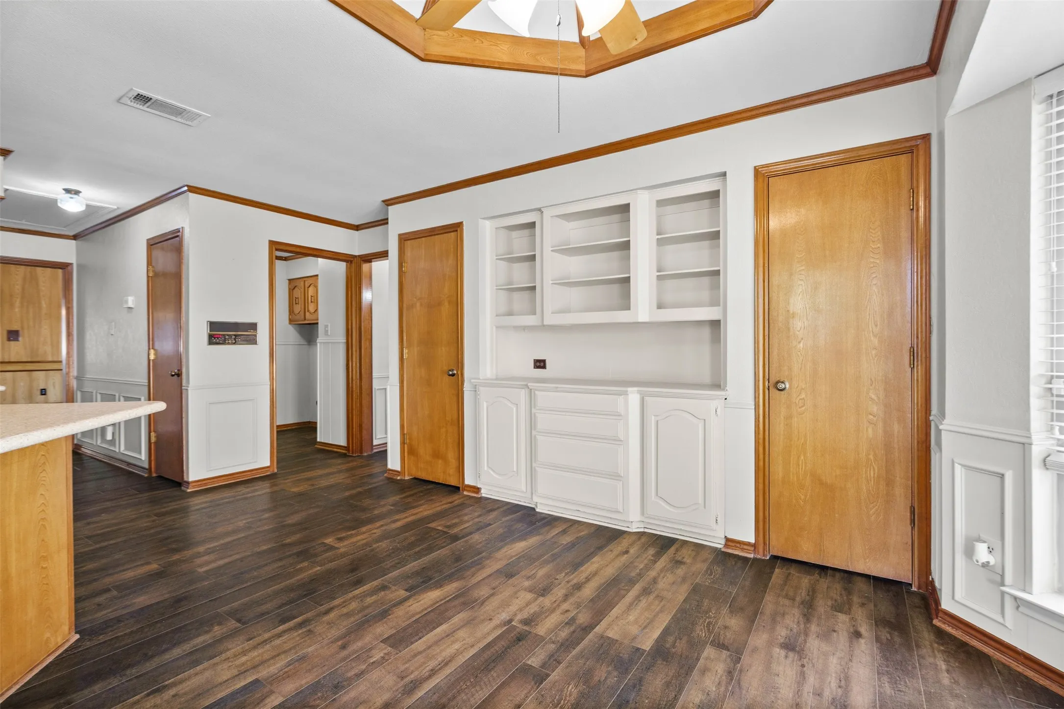 Dining area with vaulted ceilings, built in storage, and 2 pantries.