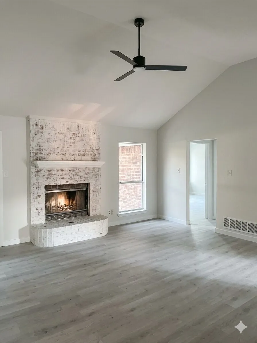 Spacious living area featuring a vaulted ceiling and a modern ceiling fan
