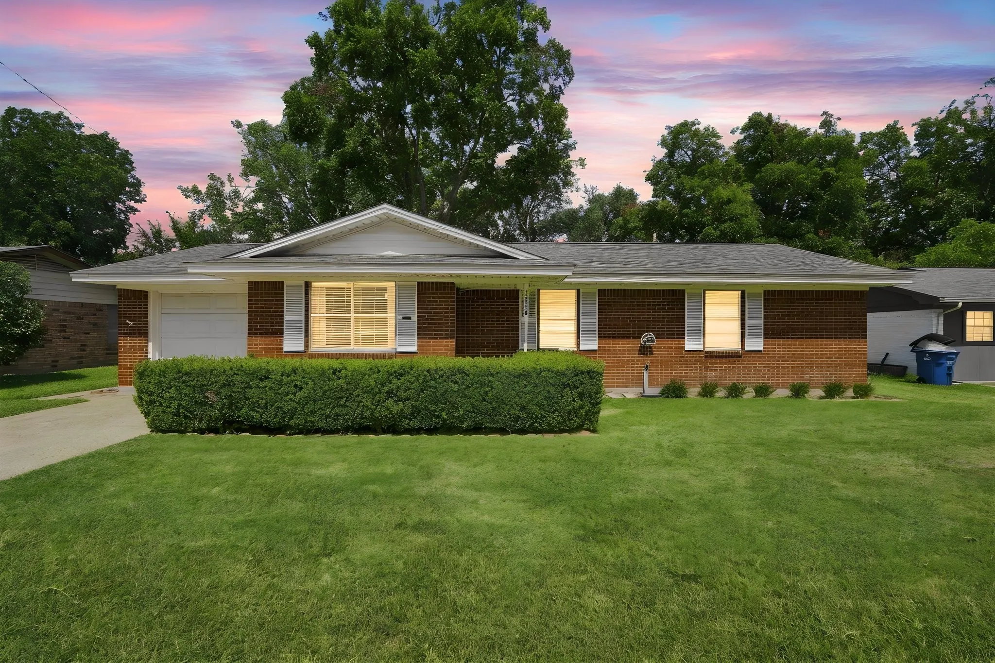 Brick exterior with white window shutters and a gabled porch entry