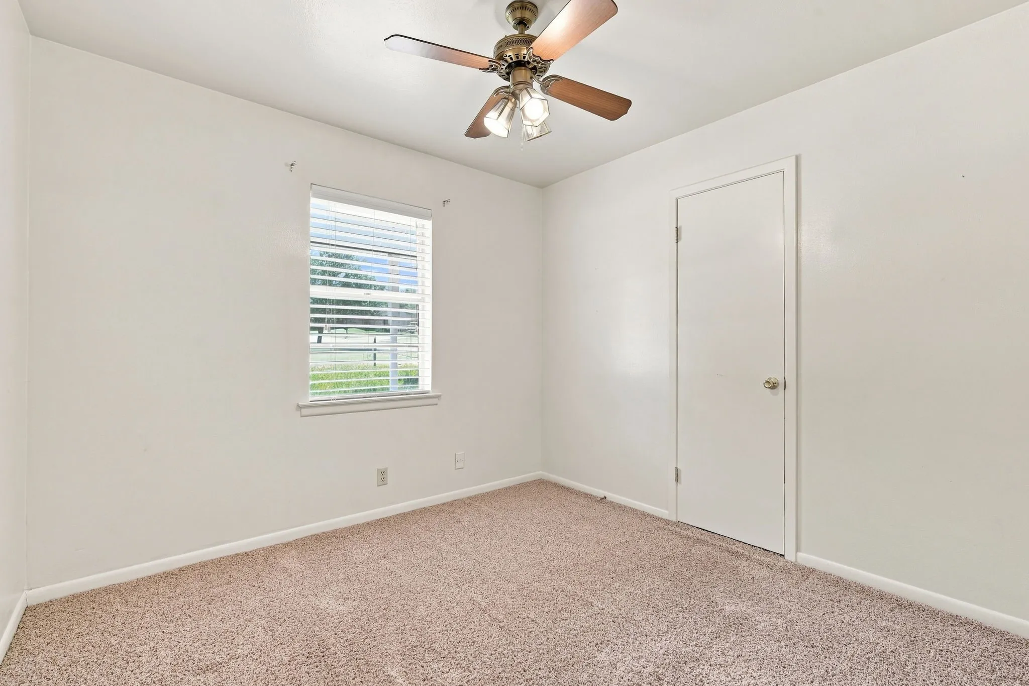 Room with neutral carpeting and white walls