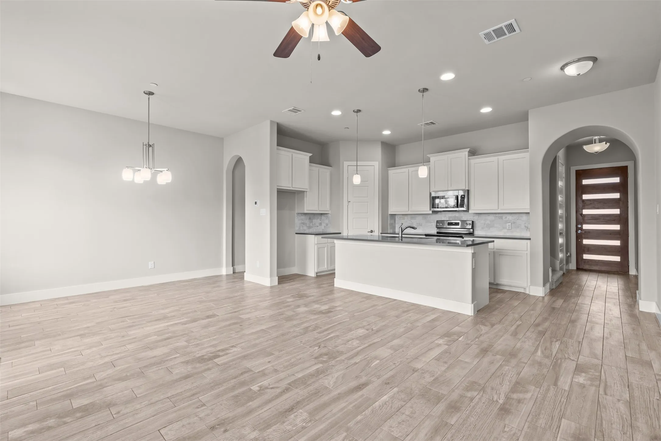 Downstairs is an open concept kitchen, living, and dining setup