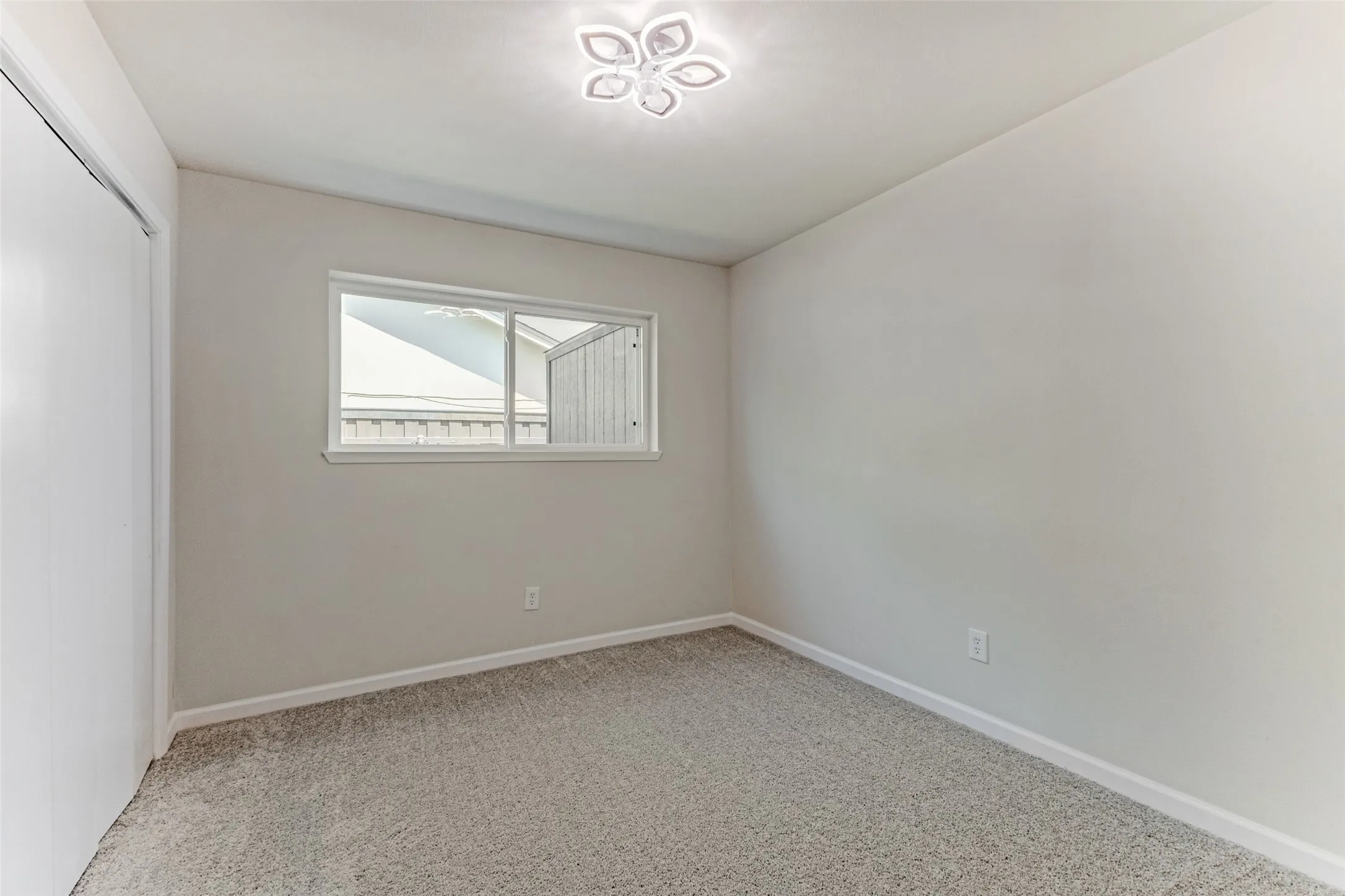 Neutral-toned wall finishes with a ceiling-mounted decorative light fixture