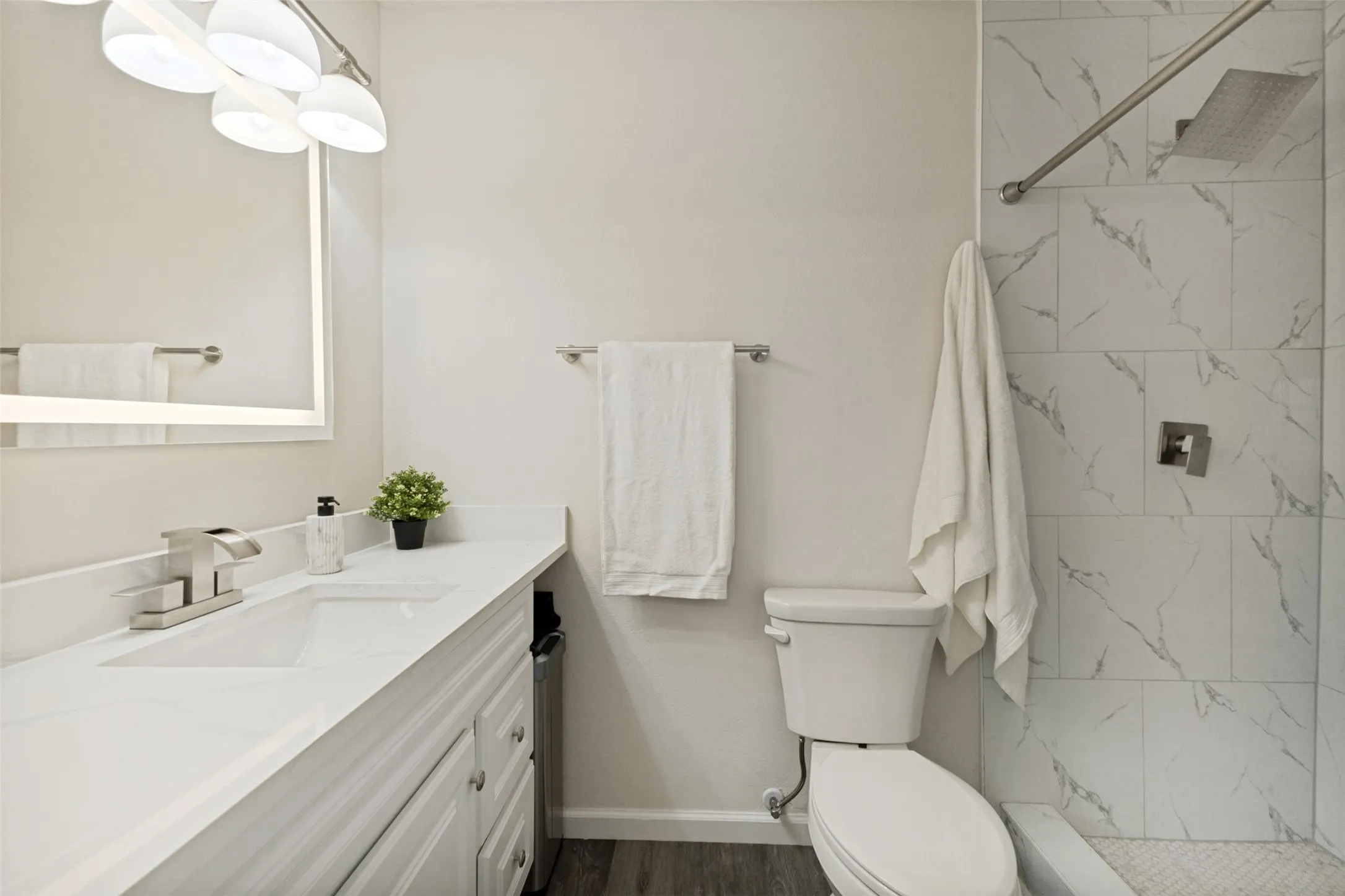 Bathroom featuring a vanity with a white countertop, undermount sink, and brushed nickel faucet