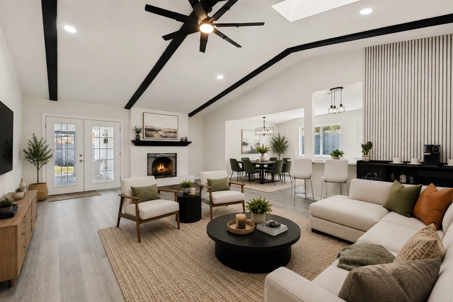 Vaulted ceilings with exposed beams and a skylight illuminate this living space