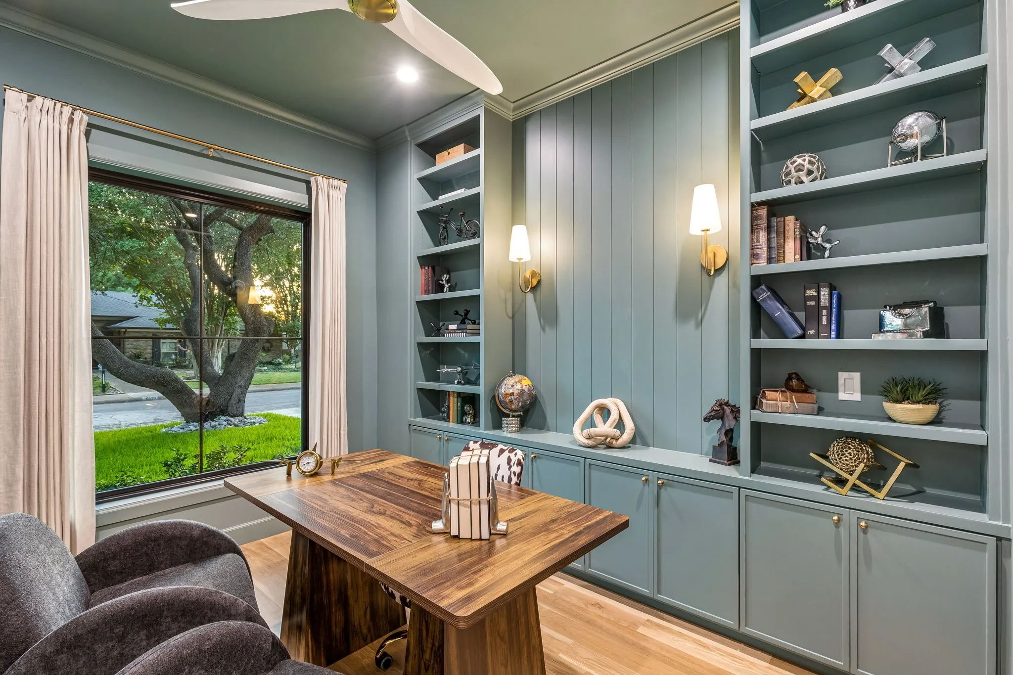 Office with custom cabinetry overlooking the front yard