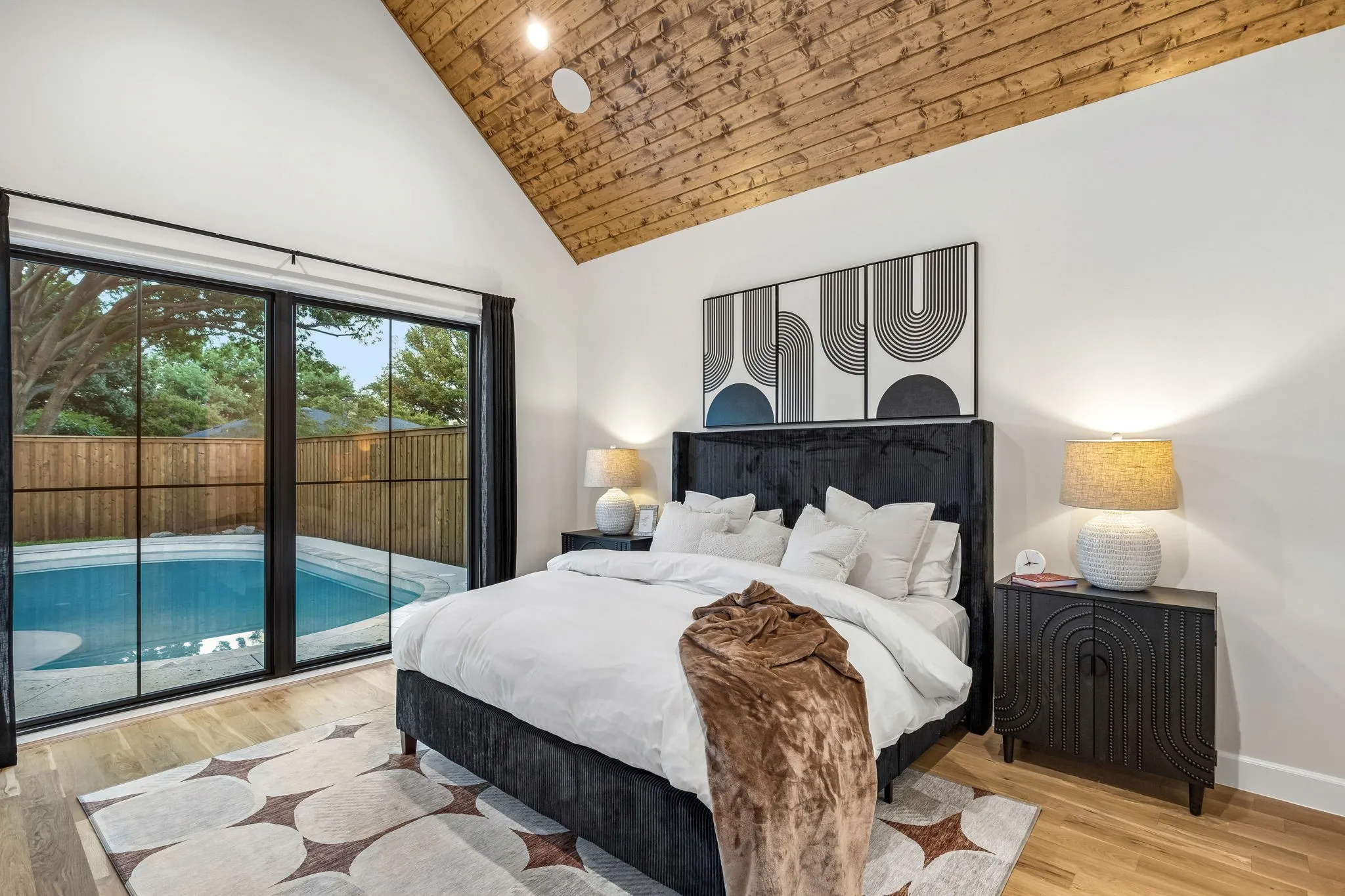 Primary bedroom overlooking the backyard oasis