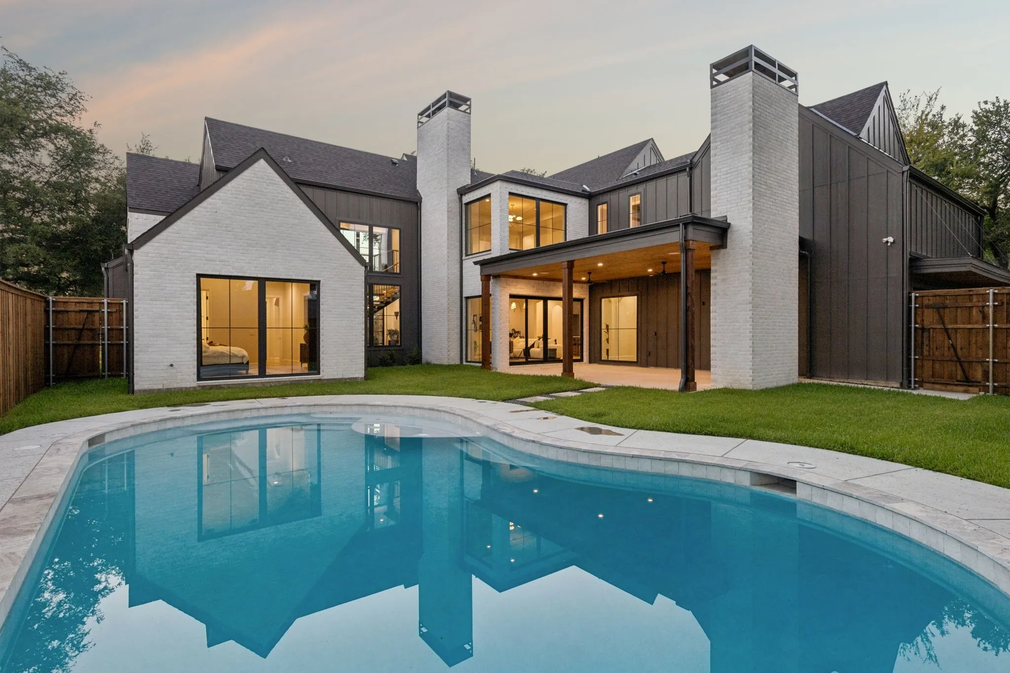 Backyard with covered patio, greenspace and in ground pool