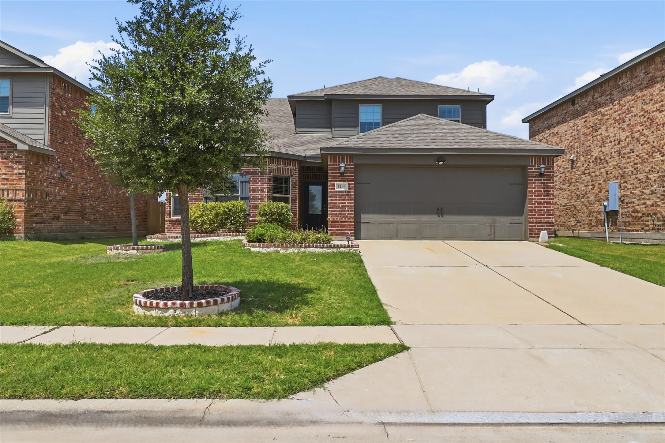 Brick and siding exterior with an attached two-car garage