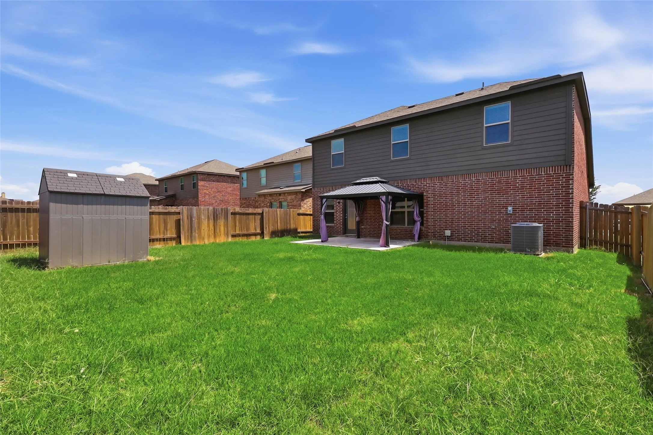 Expansive green lawn with a wood privacy fence
