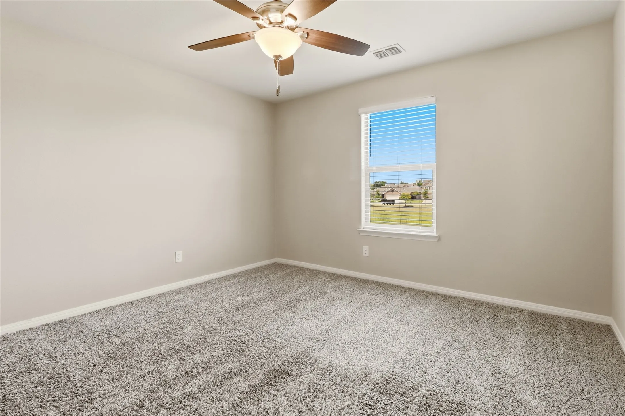 Carpeted interior space with neutral wall tones