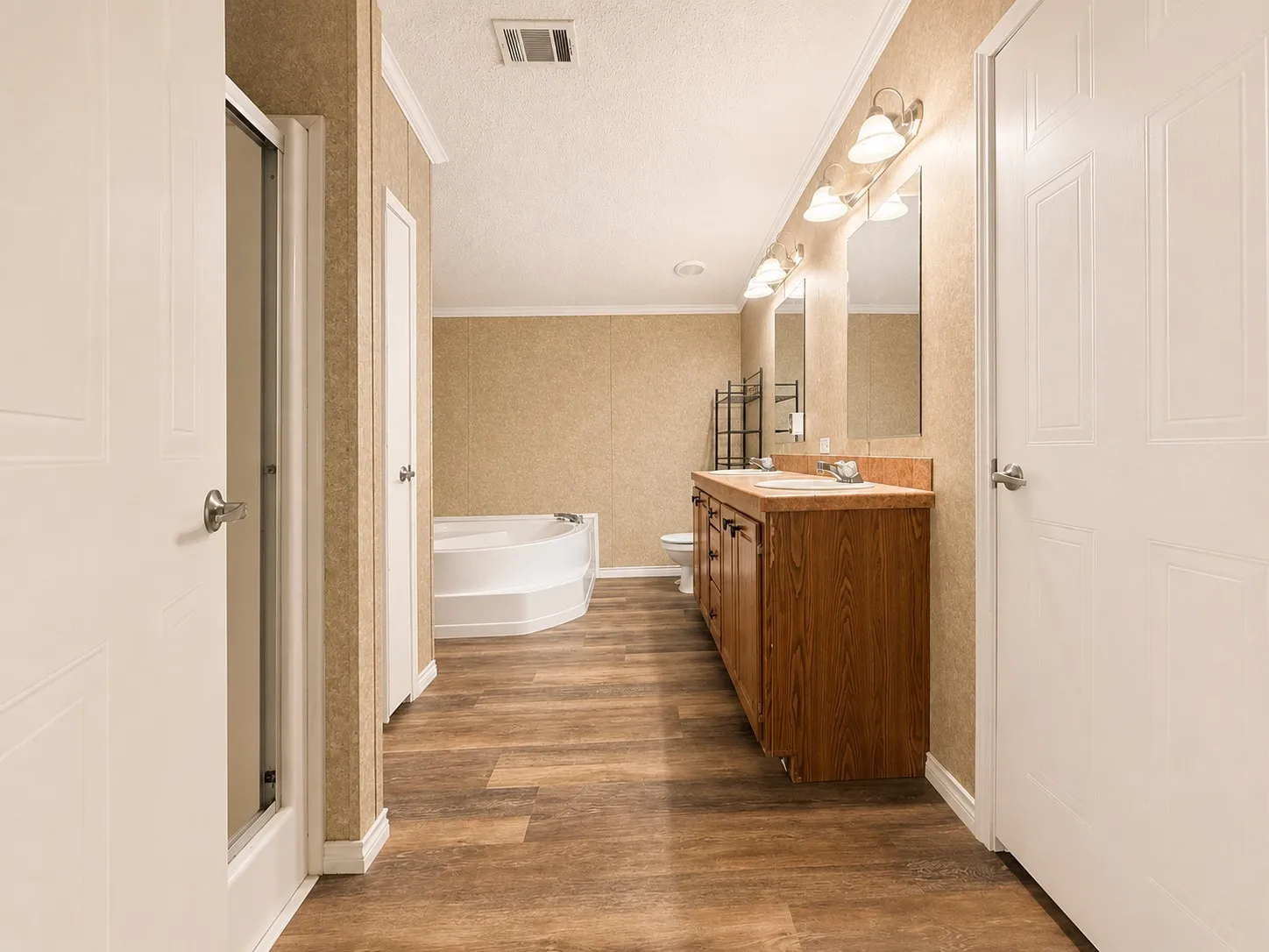 Bathroom with wood-finish flooring and textured wall panels