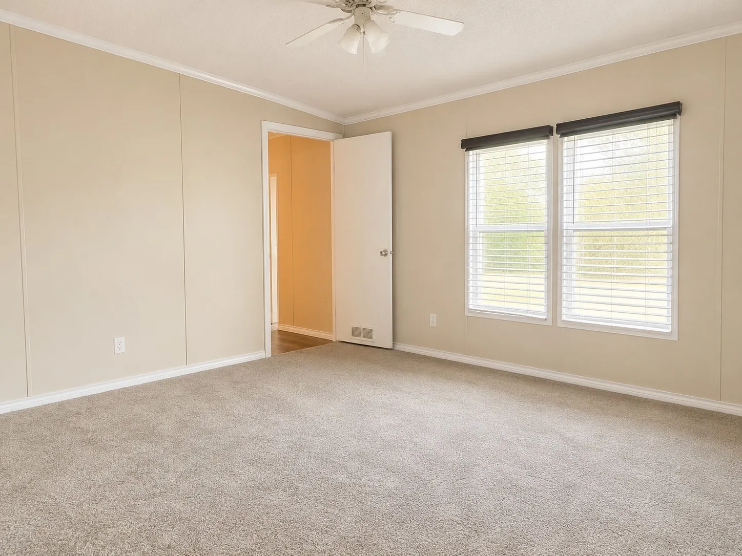 Spacious room featuring neutral carpeting and light-toned walls