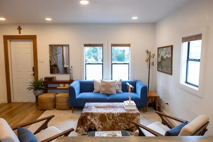 Living space featuring recessed lighting, light wood-finish flooring, white walls, and multiple windows with wood trim