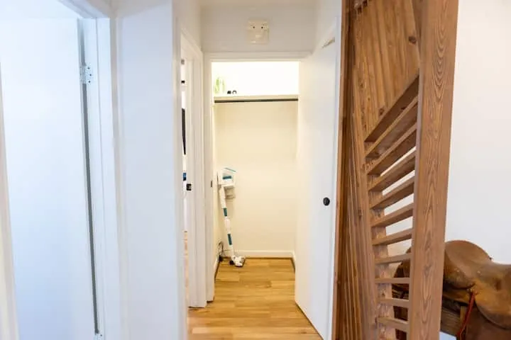 Hallway with light wood-finish flooring and white walls