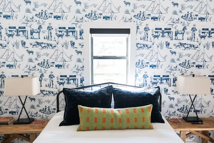 Feature wall with blue and white patterned Marfa wallpaper
