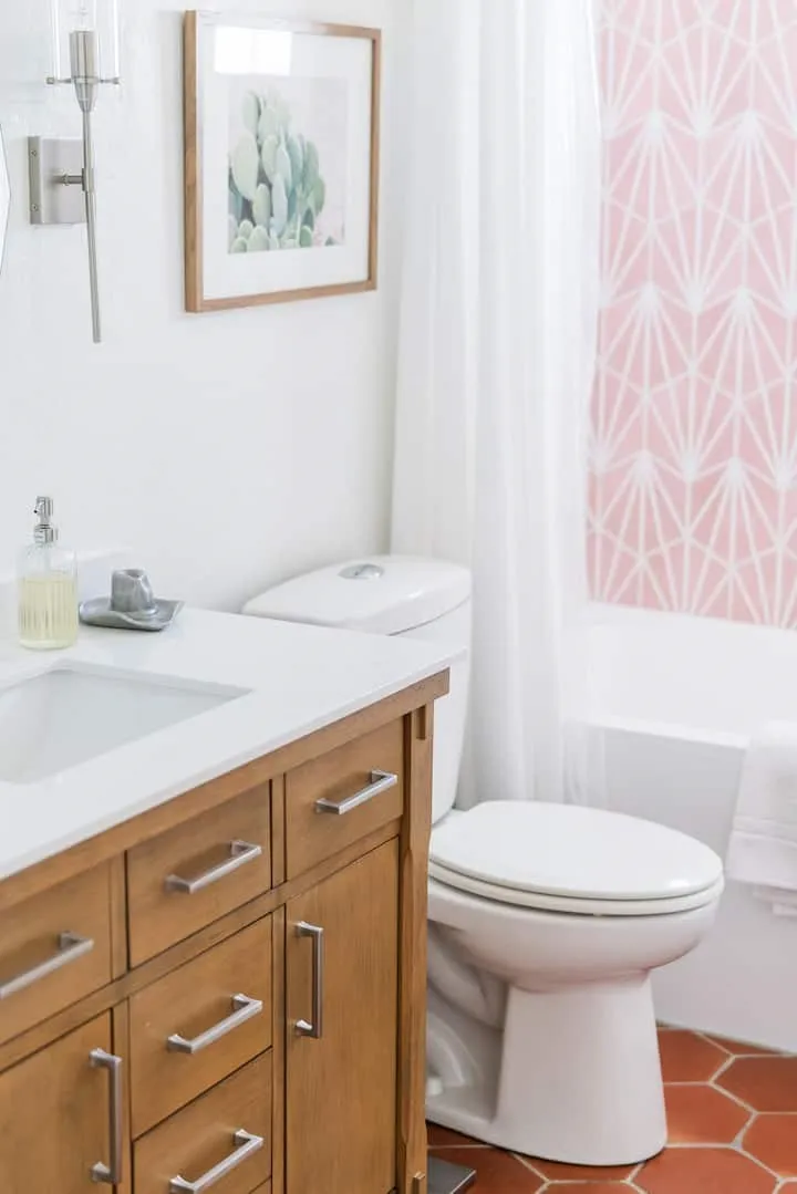 Wood-finish vanity with an integrated sink and white countertop