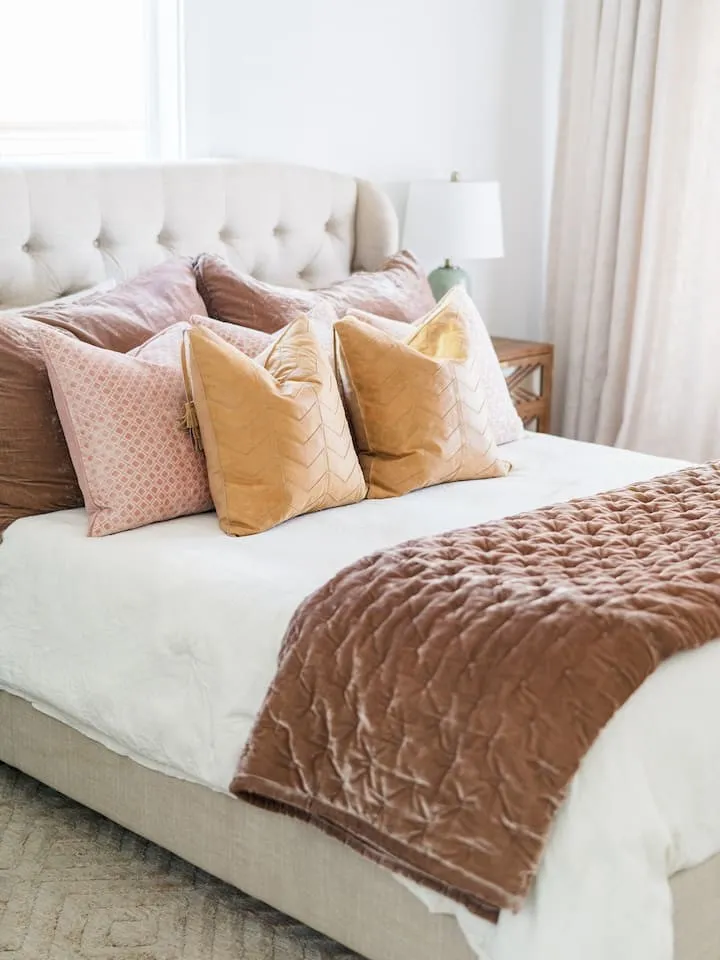 Upholstered tufted headboard, recessed window, and light-toned walls