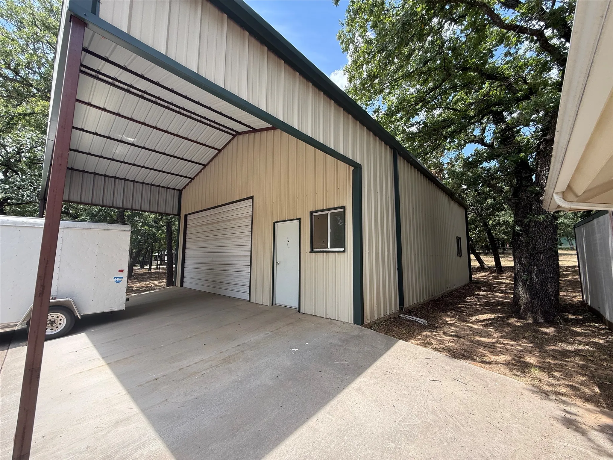 front of workshop with carport