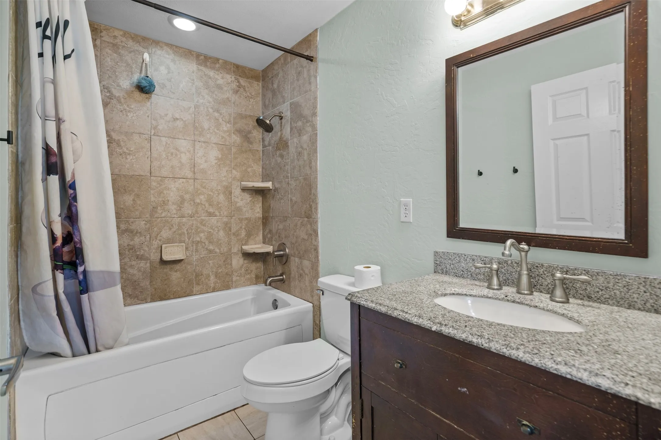 Bathroom vanity with a stone countertop and undermount sink