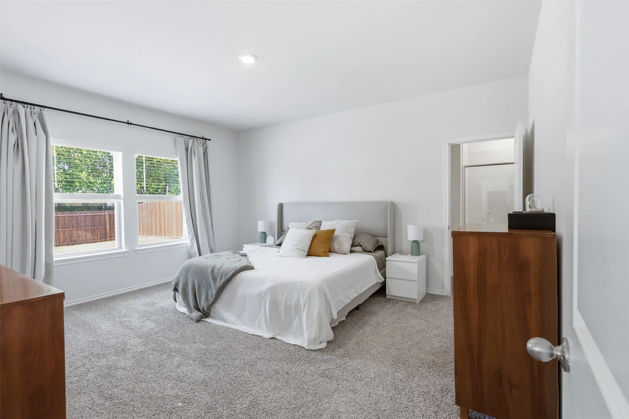 Bright primary bedroom featuring plenty of natural light and space