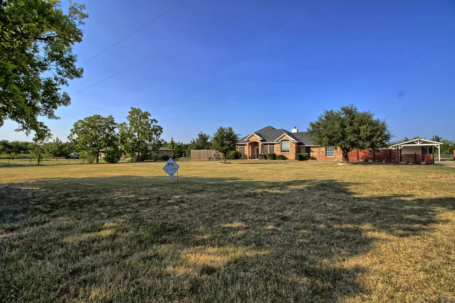 Spacious front yard with mature trees