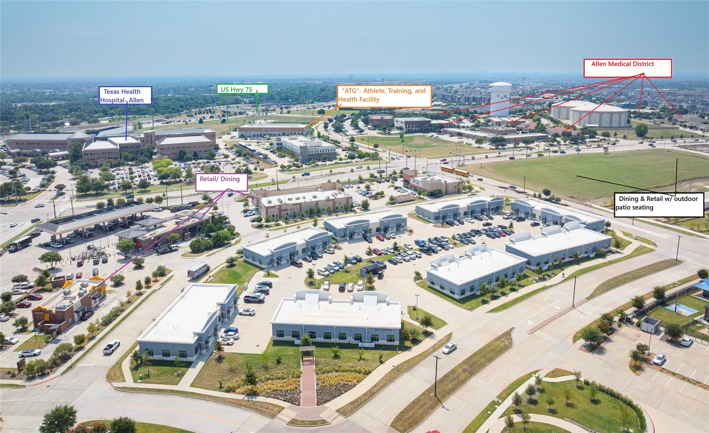 Commercial development featuring multiple buildings, extensive parking areas, and mature landscaping