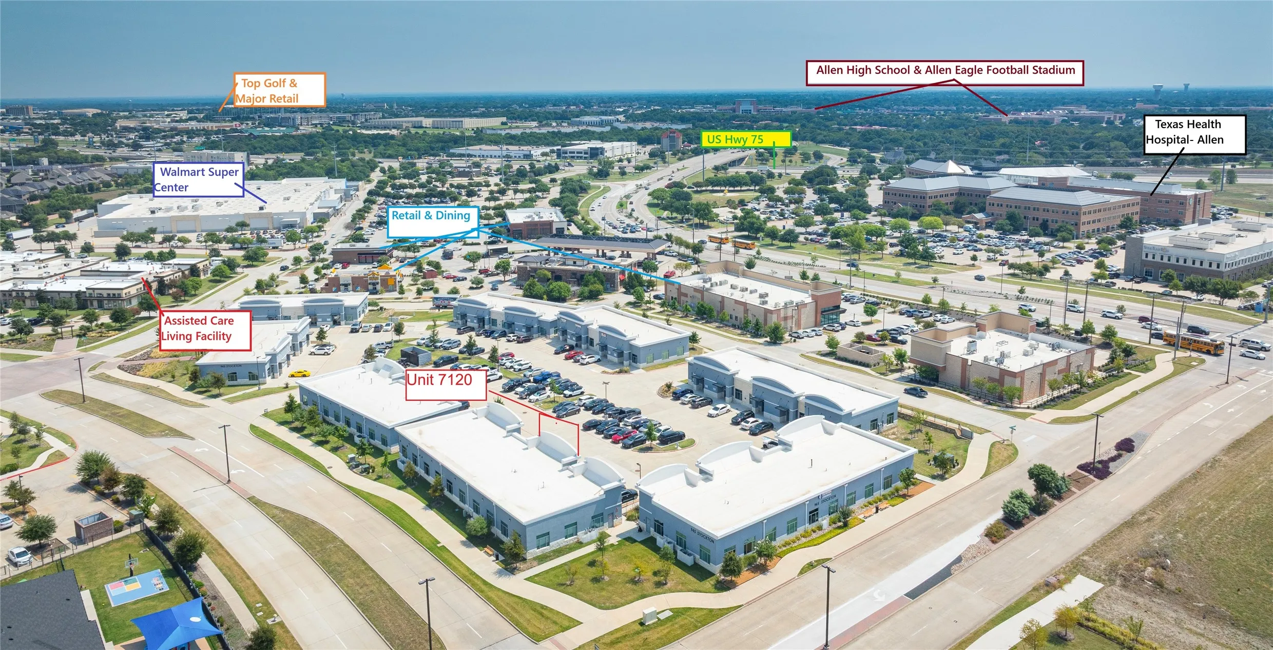 Aerial perspective showcasing a commercial development with multiple buildings and a parking lot