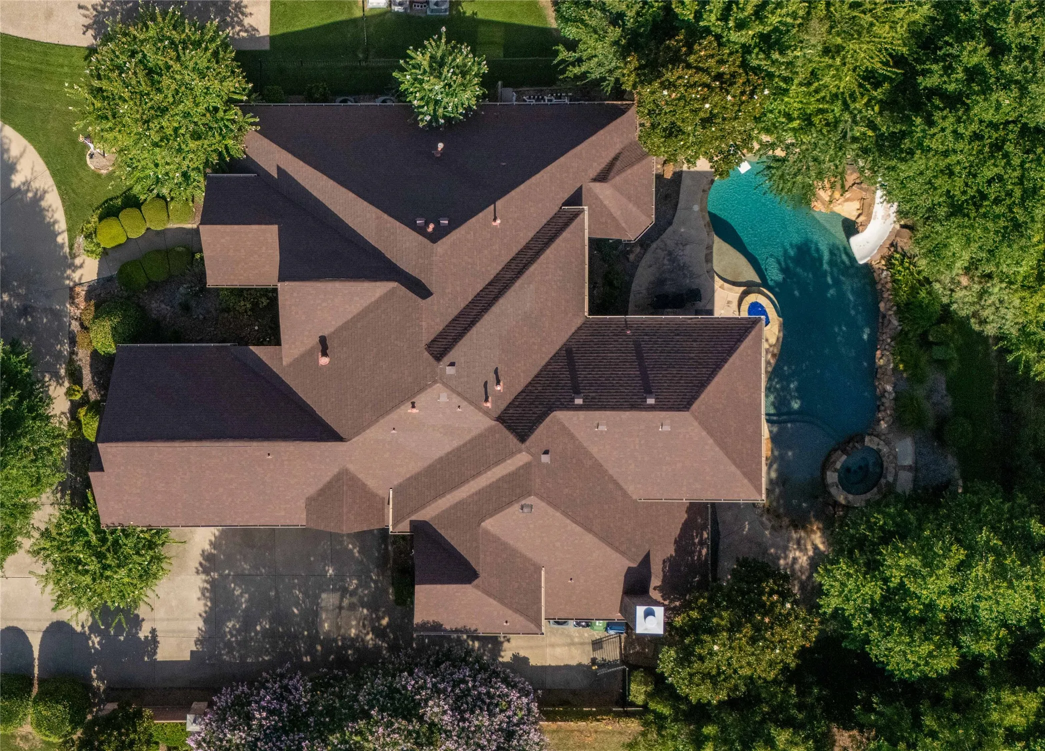 Aerial perspective showcasing a multi-gabled roofline and an outdoor leisure area