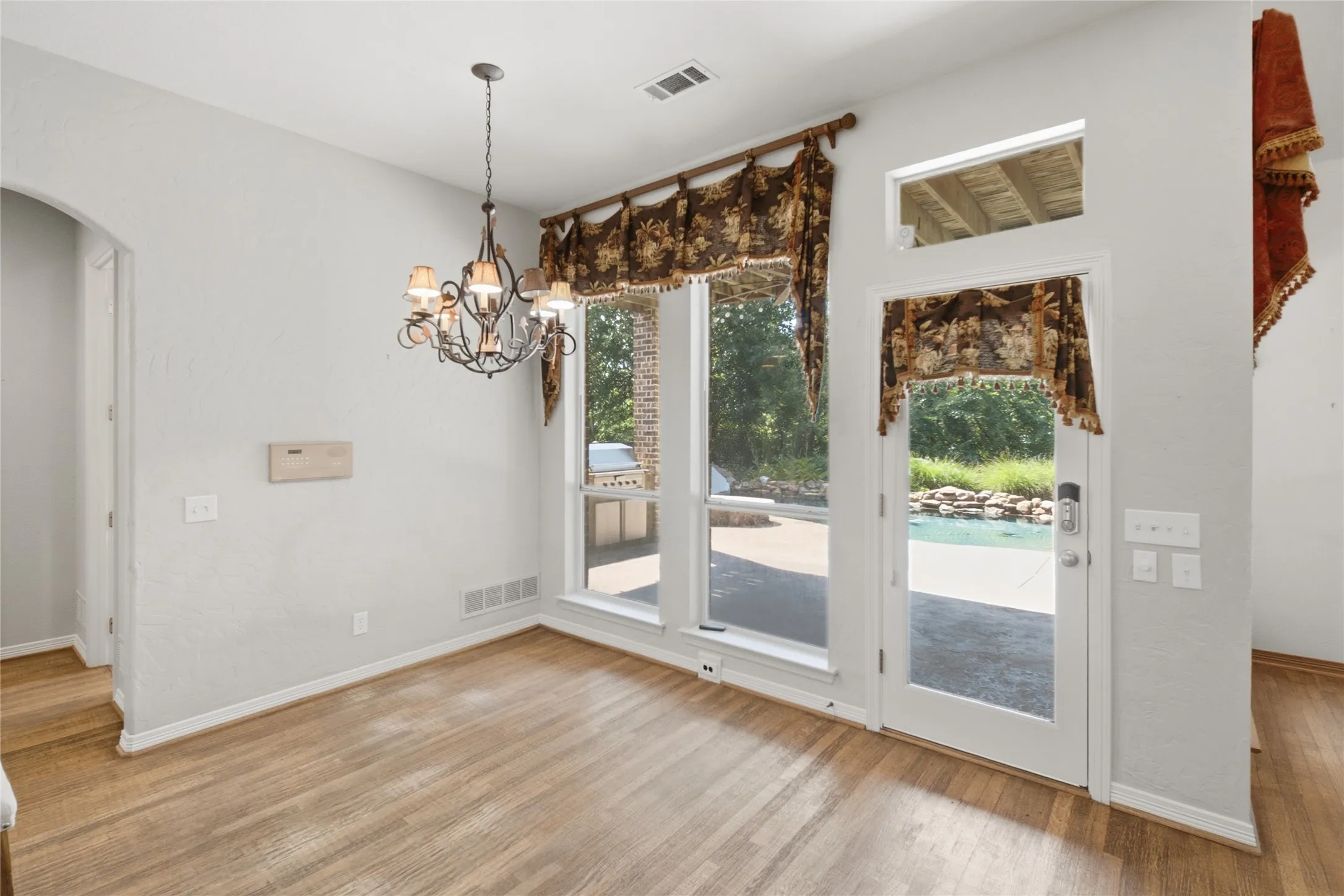 Dining area featuring wood-finish flooring and an ornate chandelier