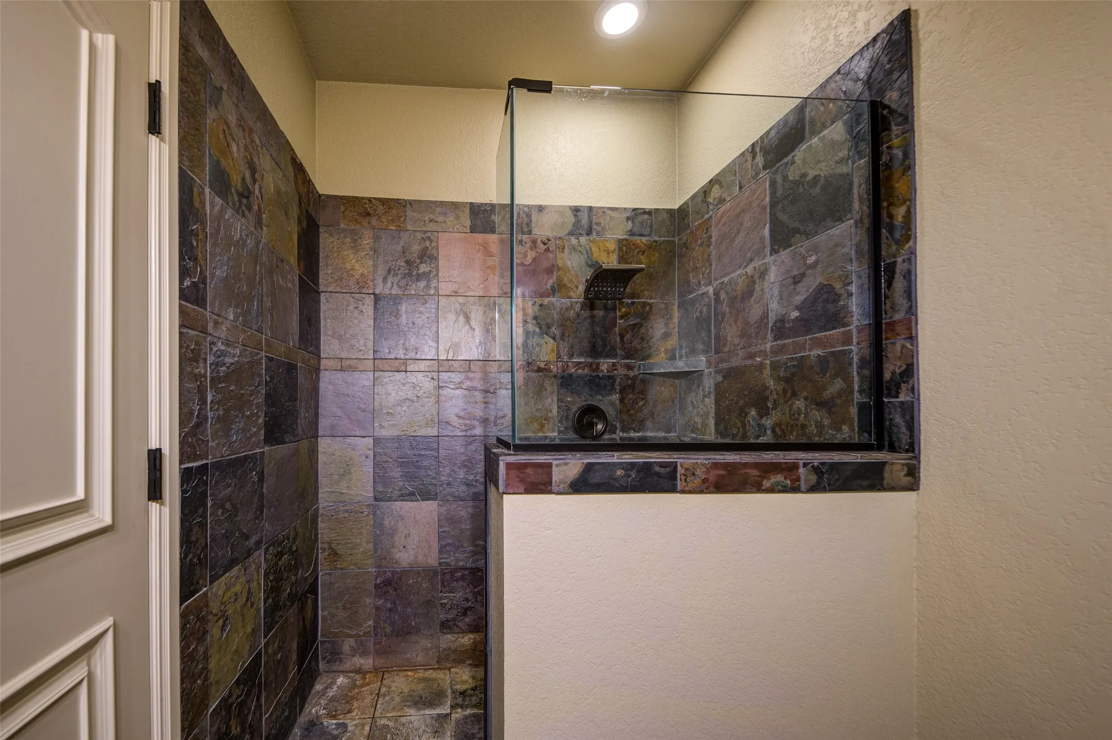 anity area featuring a single basin, ample countertop space, wood-finish cabinetry with decorative hardware, a full-width mirror, and overhead vanity lighting