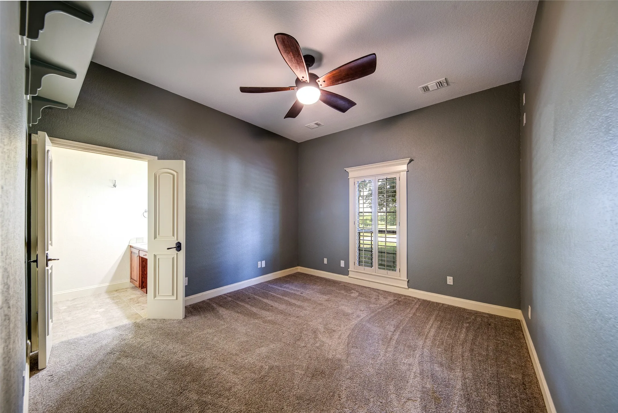 Bedroom 4 featuring a ceiling fan with light fixture, crown molding, and neutral wall paint