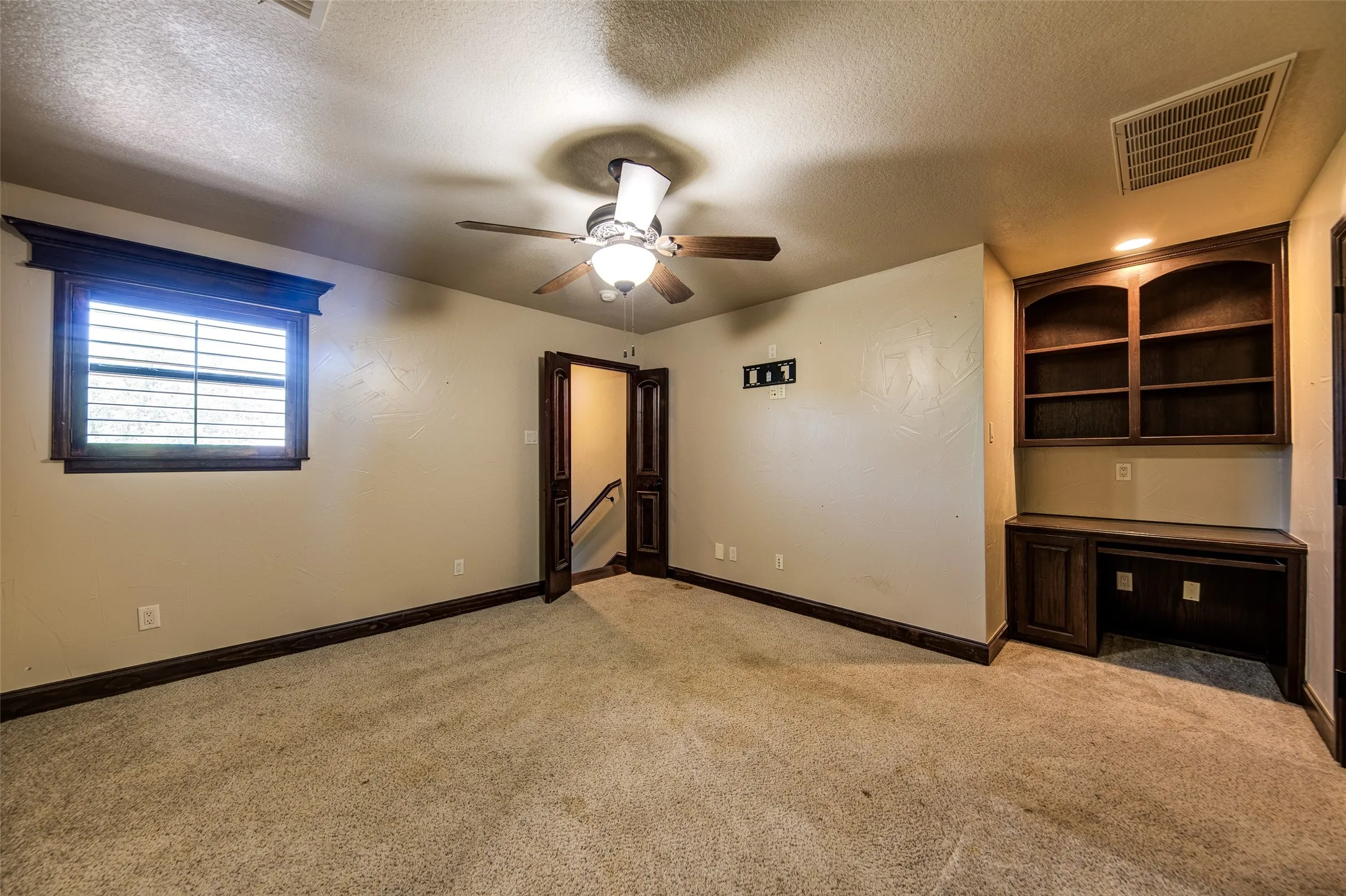 Bedroom 5 featuring a ceiling fan with light fixture, crown molding, and neutral wall paint