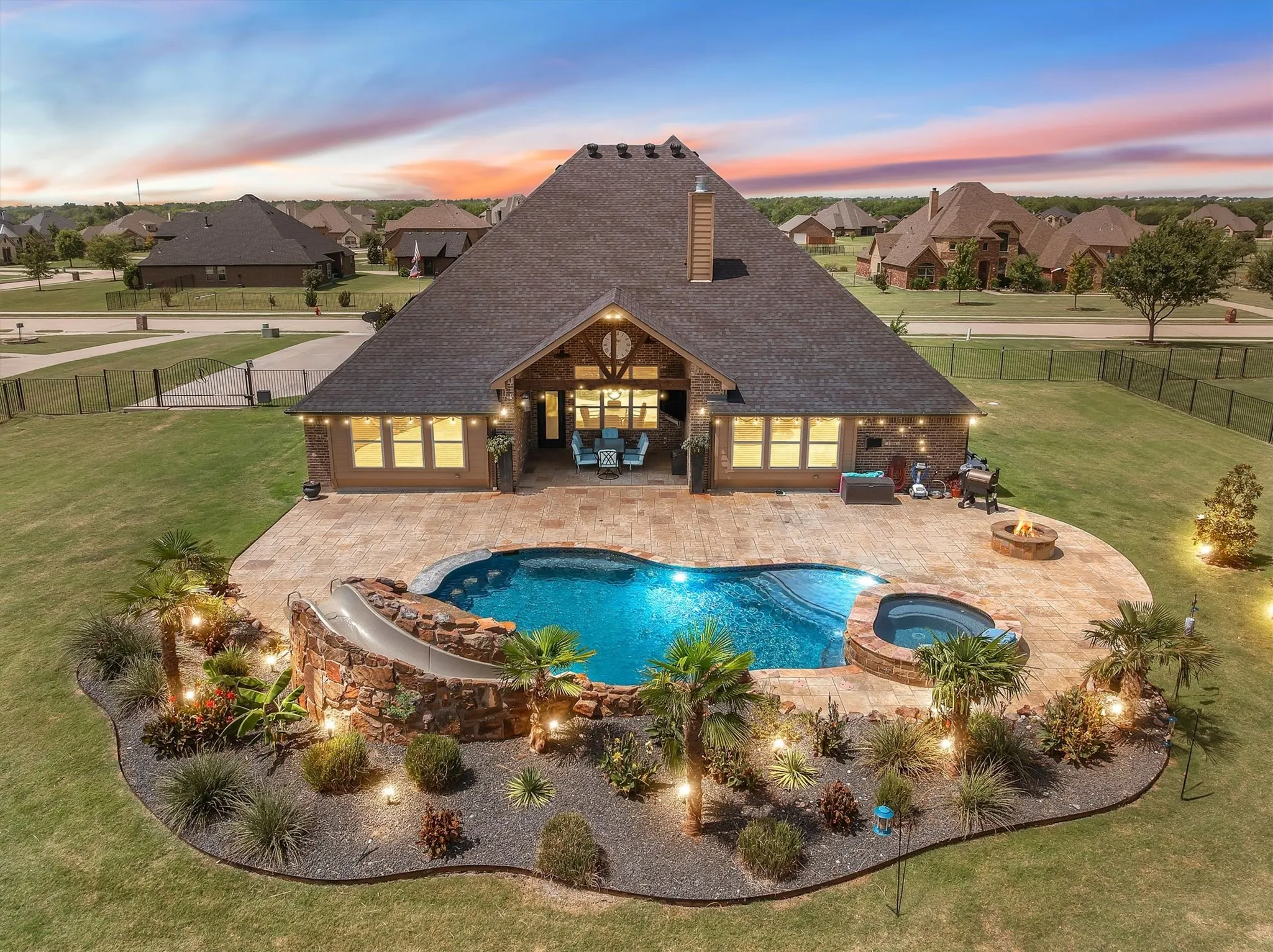 Back elevation with a heated saltwater pool and professional landscapting at 413 Cattle Barron Drive, Rockwall, Tx, Rockwall County, Chisholm Crossing