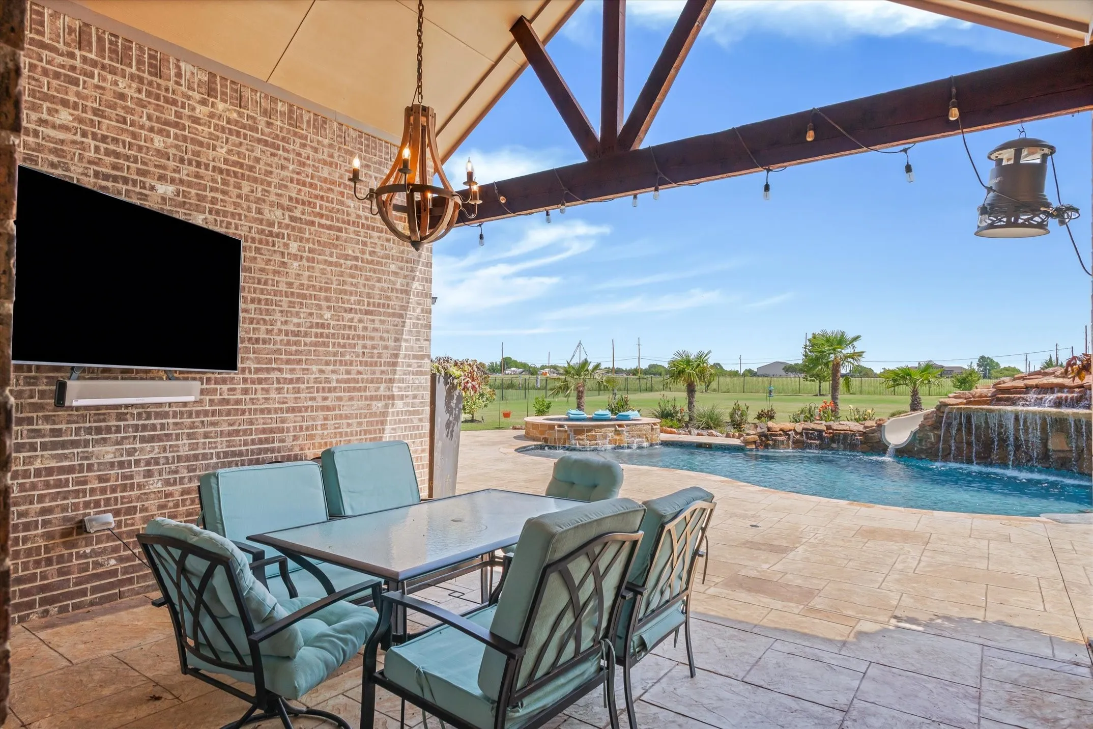 Covered back porch with Sonos sound system Primary bedroom over looking the heated saltwater pool at 413 Cattle Barron Drive, Rockwall, Tx, Rockwall County, Chisholm Crossing
