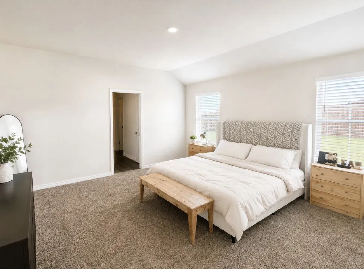 Spacious room featuring vaulted ceilings and recessed lighting