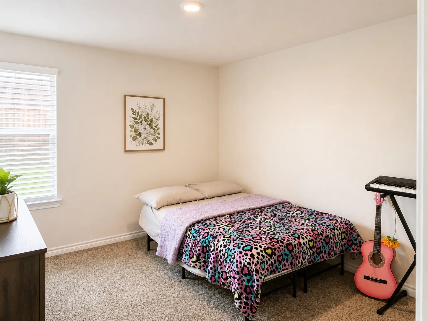 Carpeted room with a large window featuring blinds, a light cream wall color, and a recessed ceiling light fixture