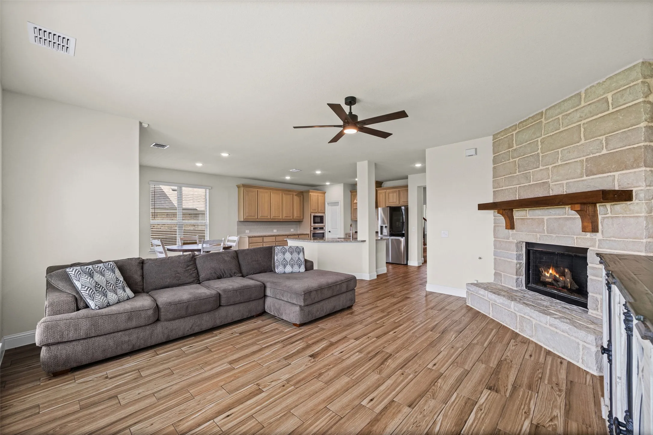Living room is open to the kitchen and has a gorgeous stone fireplace