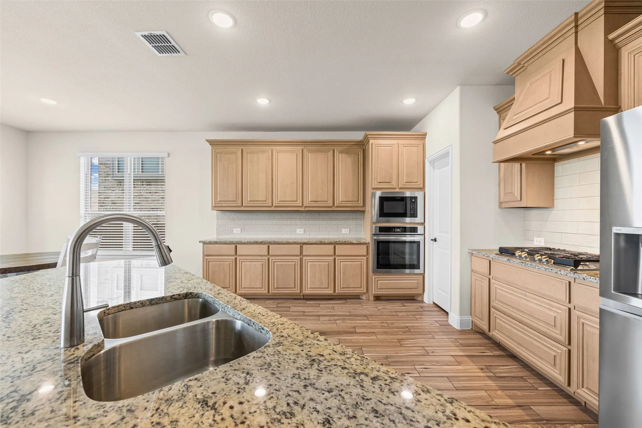Huge kitchen with stainless appliances, granite counters, island, gas cooktop, and so many cabinets!