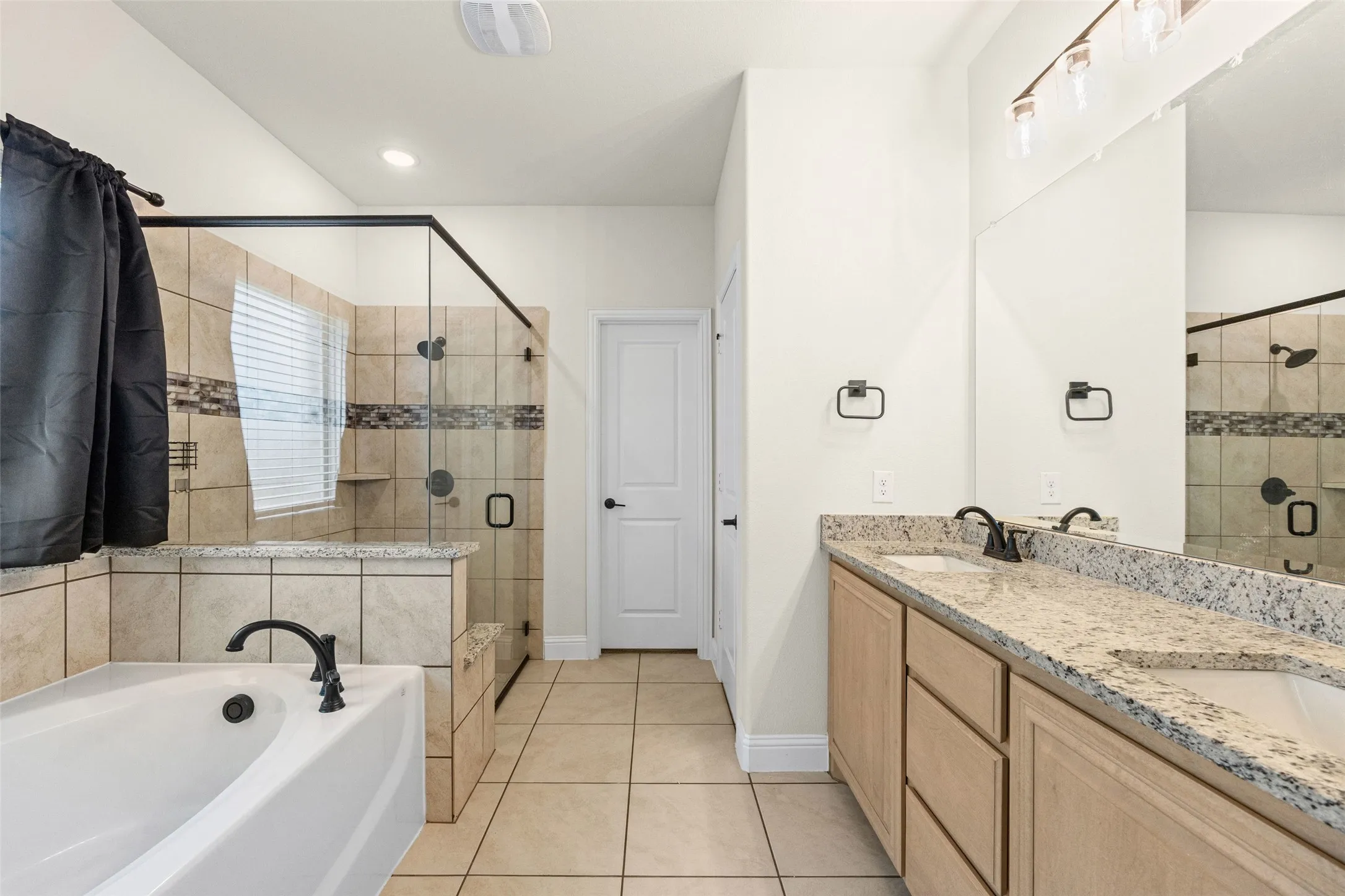 Primary bathroom has separate tub and shower and double sinks