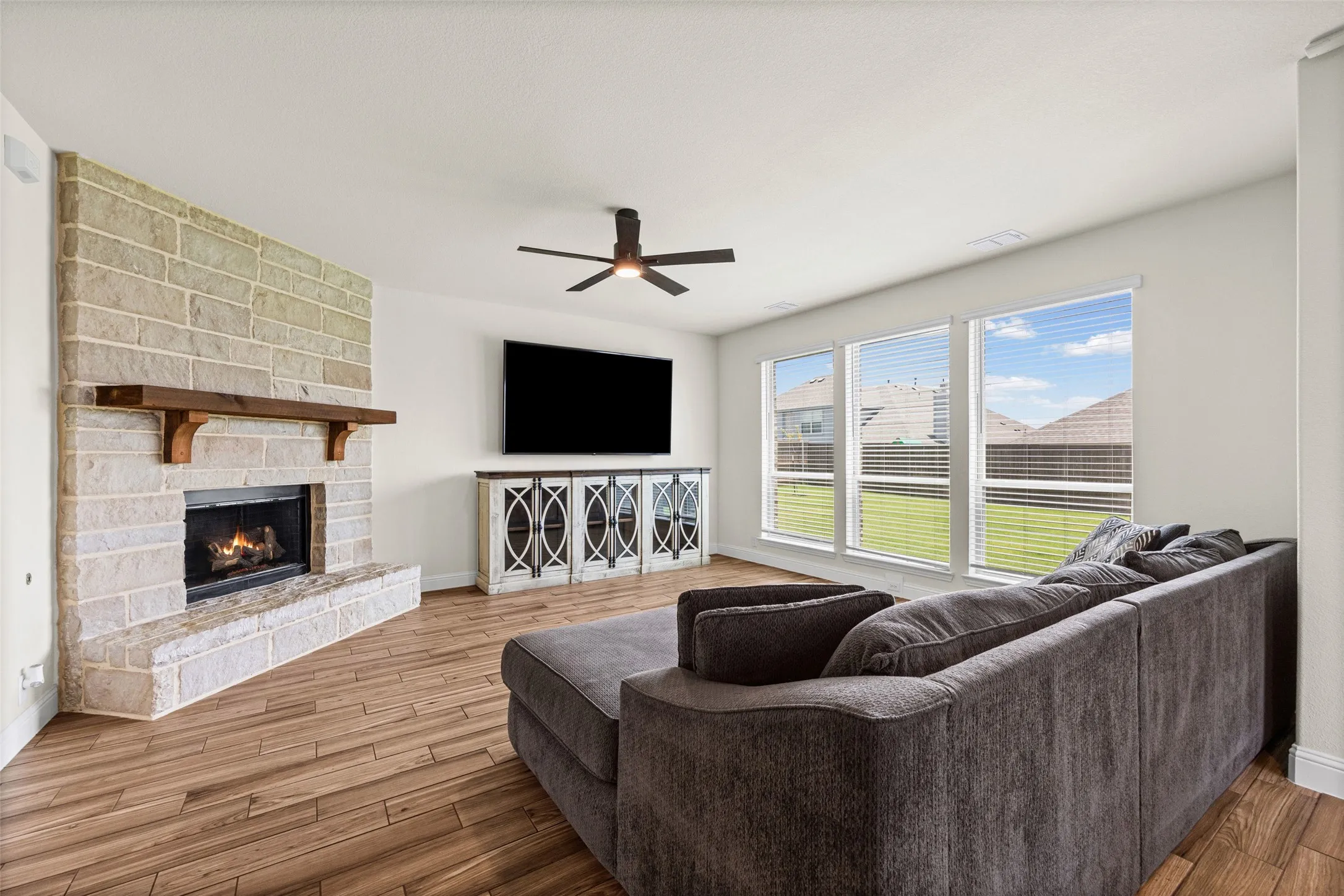 Living room is open to the kitchen and has a gorgeous stone fireplace