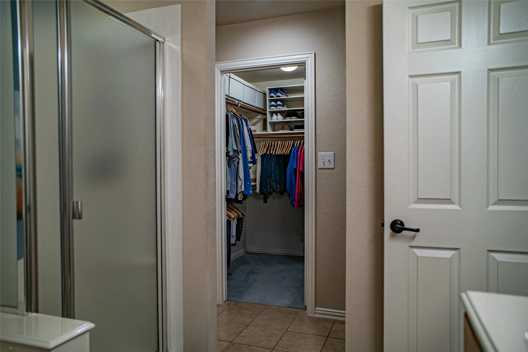 Walk-in closet with built-in shelving and hanging rods