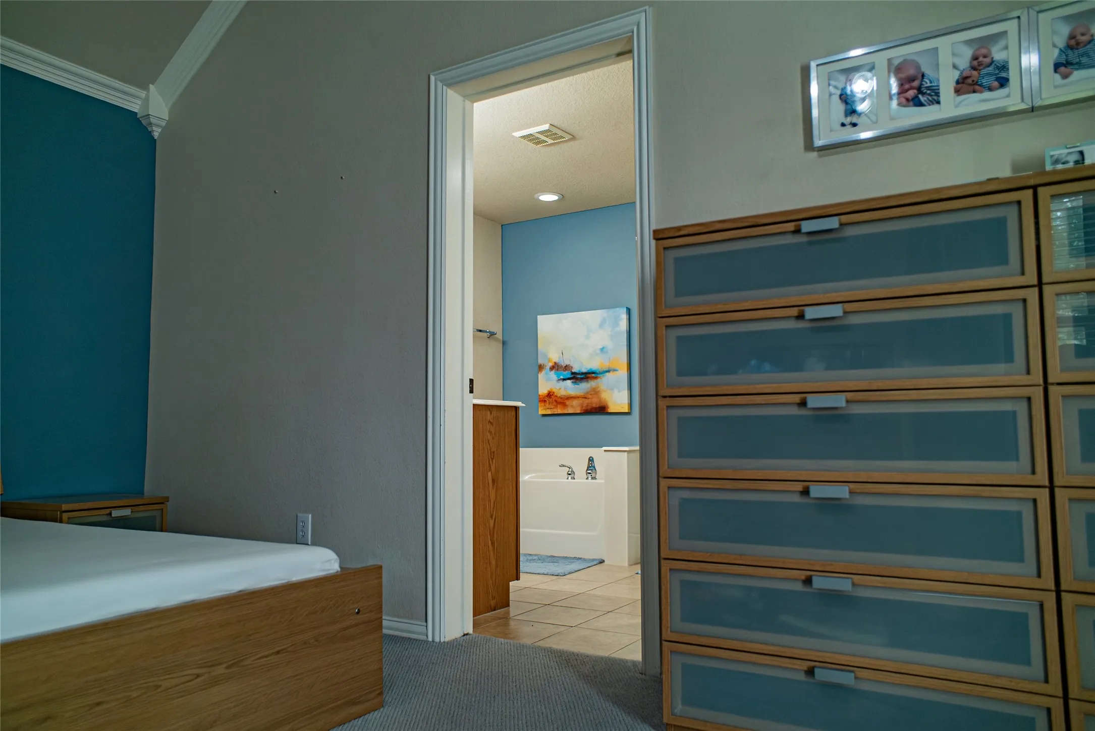 Bedroom featuring crown molding, a carpeted floor, and direct access to a bathroom