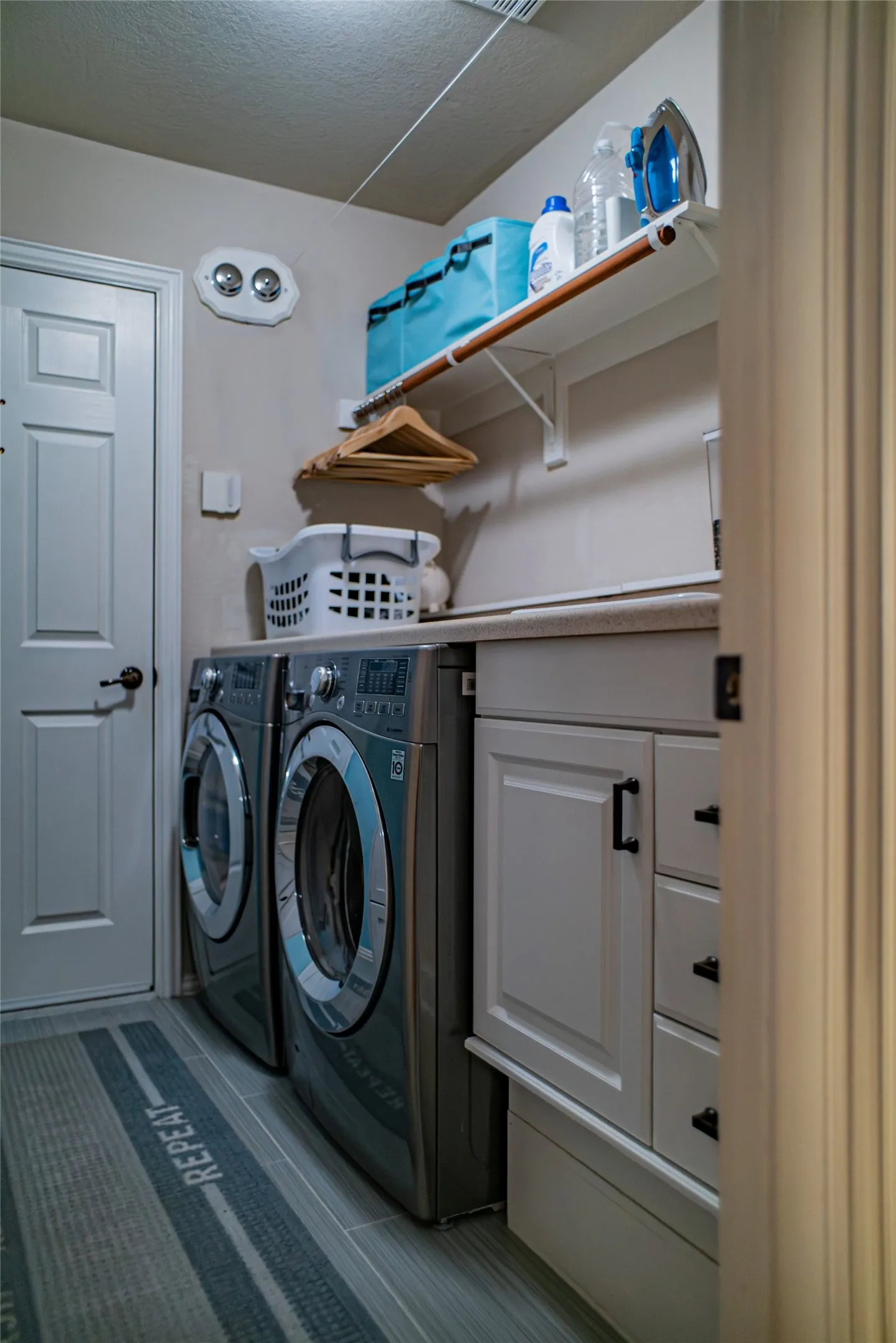 Dedicated laundry space featuring a front-loading washer and dryer set