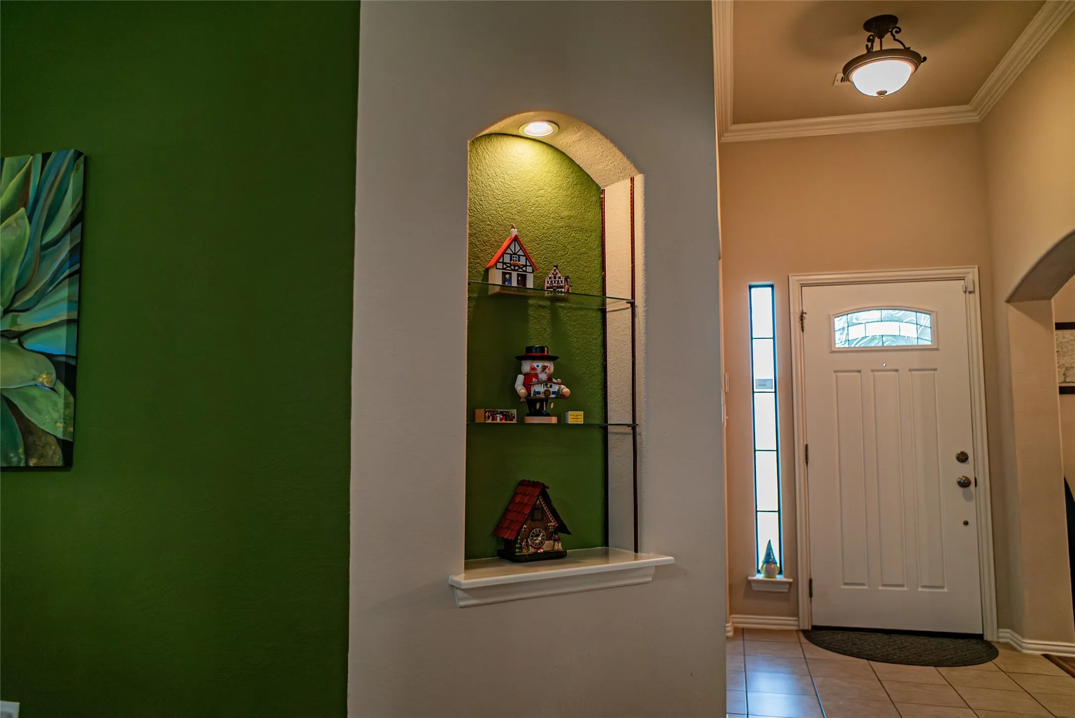 Entryway featuring a white paneled door with an arched glass insert, a full-length sidelight, and a decorative ceiling light fixture