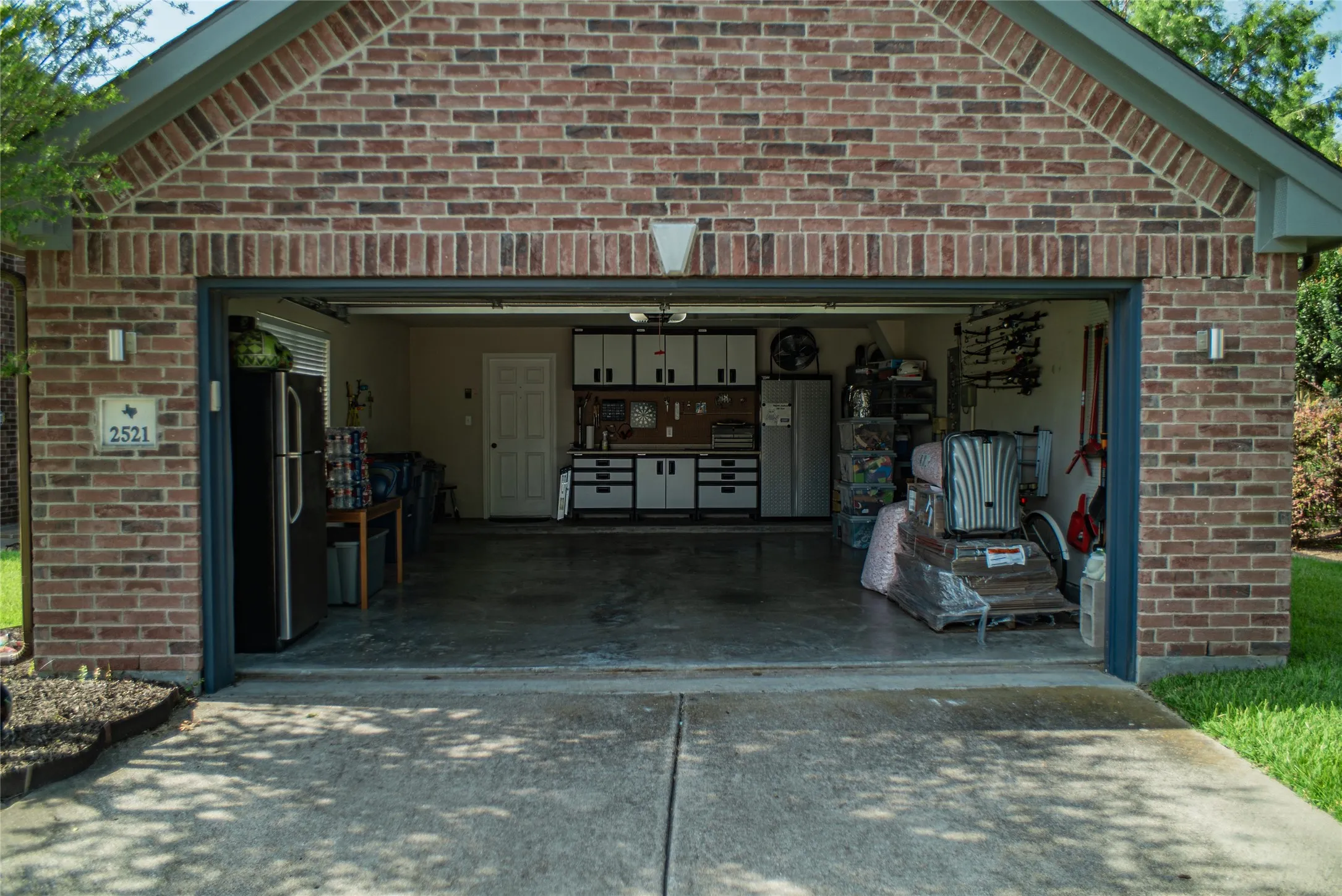 Two-car garage with a concrete driveway and brick exterior