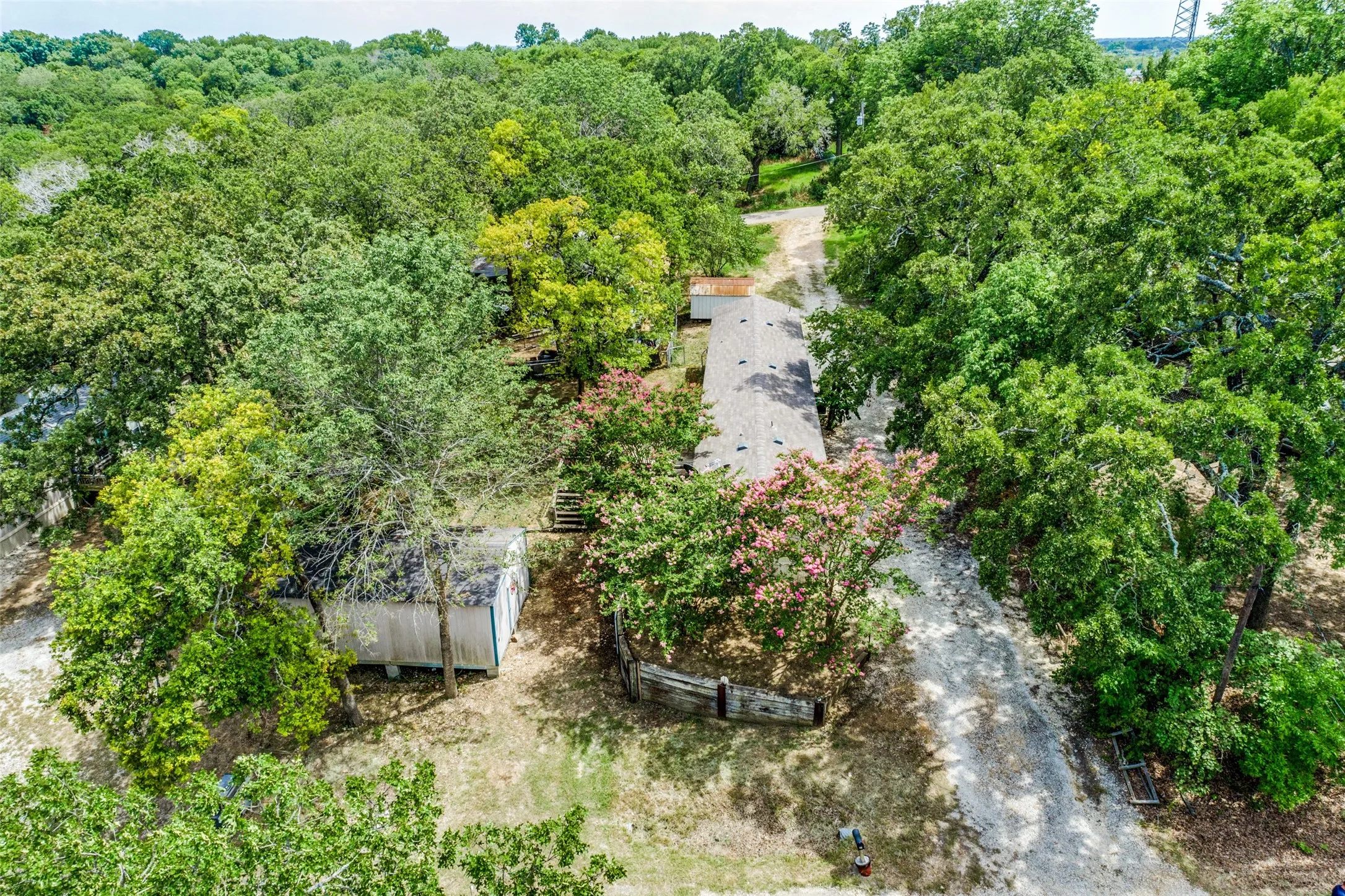 Aerial view of home with driveway spanning the distance between 2 streets, Epsom and Wembley.