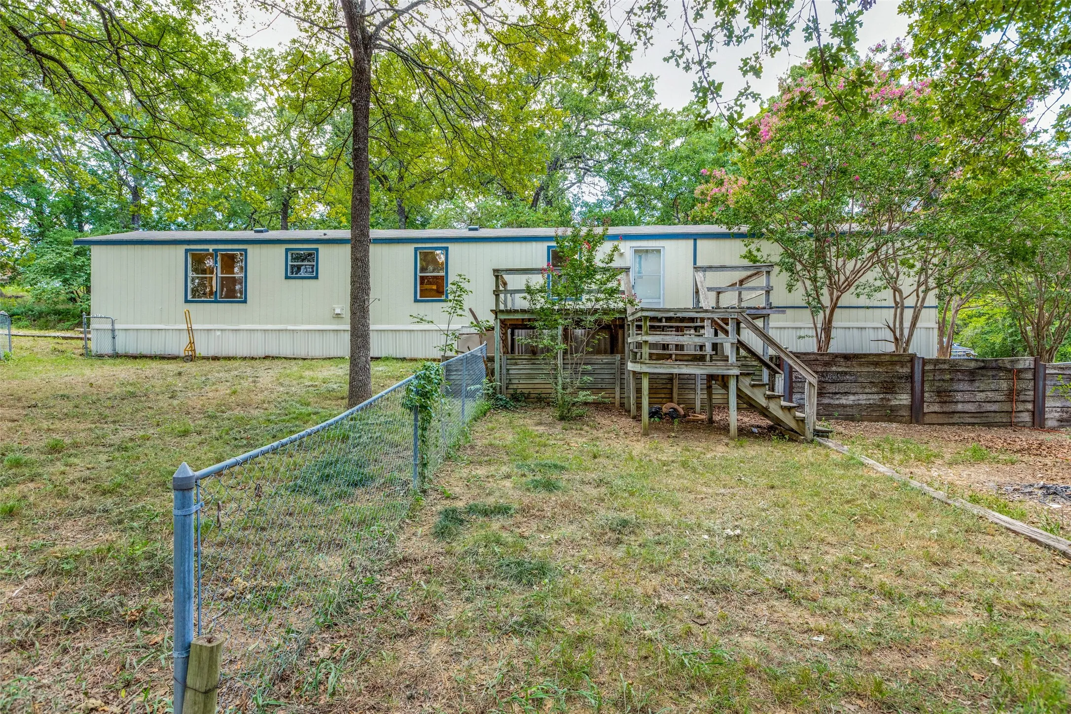 View of the fenced in back yard with 18 ft x 12 ft. deck, great for entertaining.