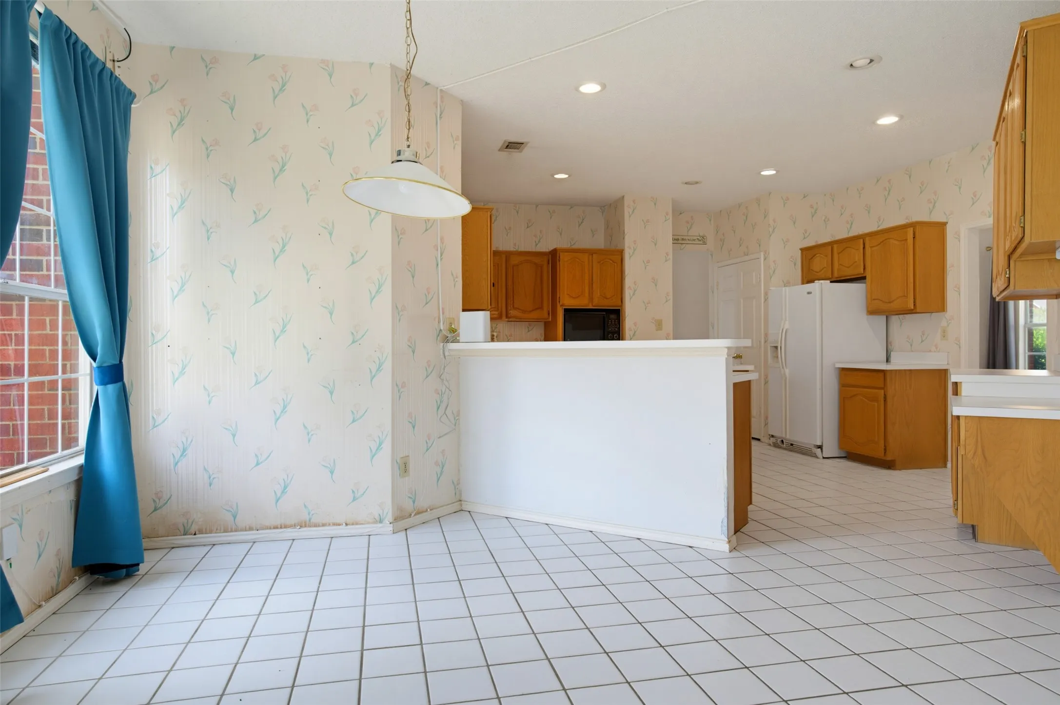 This generous Eat-In Kitchen gets the morning sunshine.